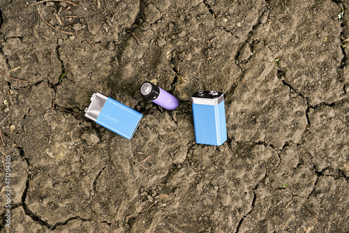 Alkaline batteries on soil outdoors photo