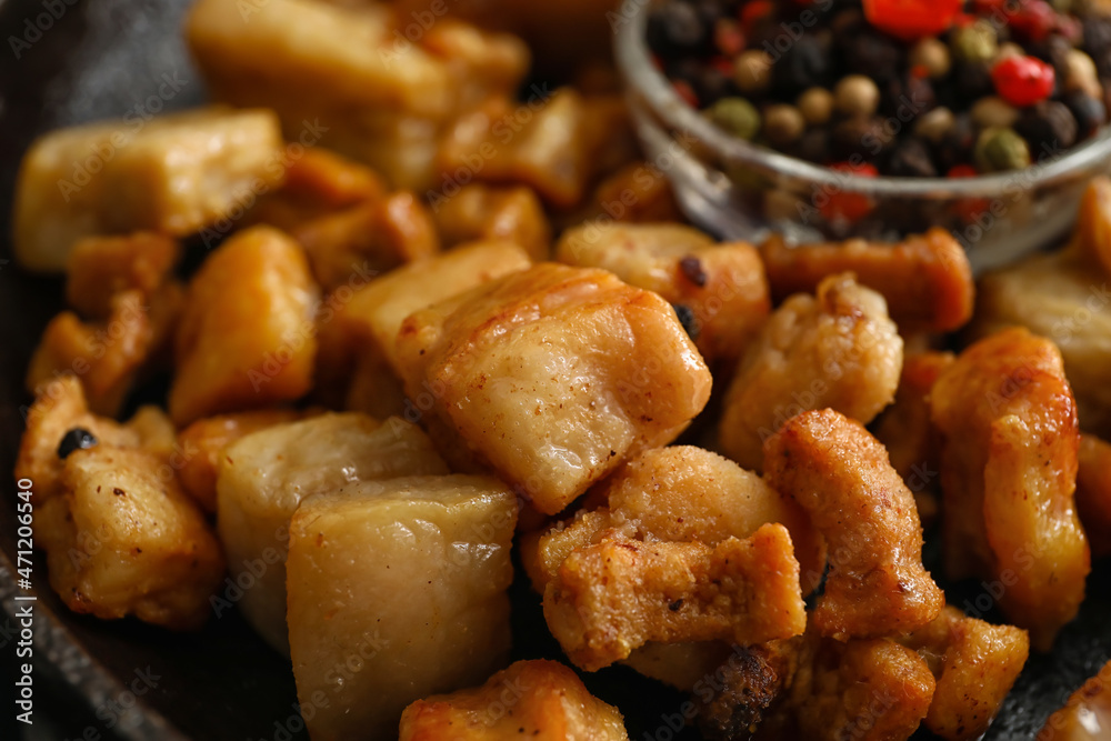 Tasty cracklings in frying pan, closeup Tasty cracklings in frying pan, closeup