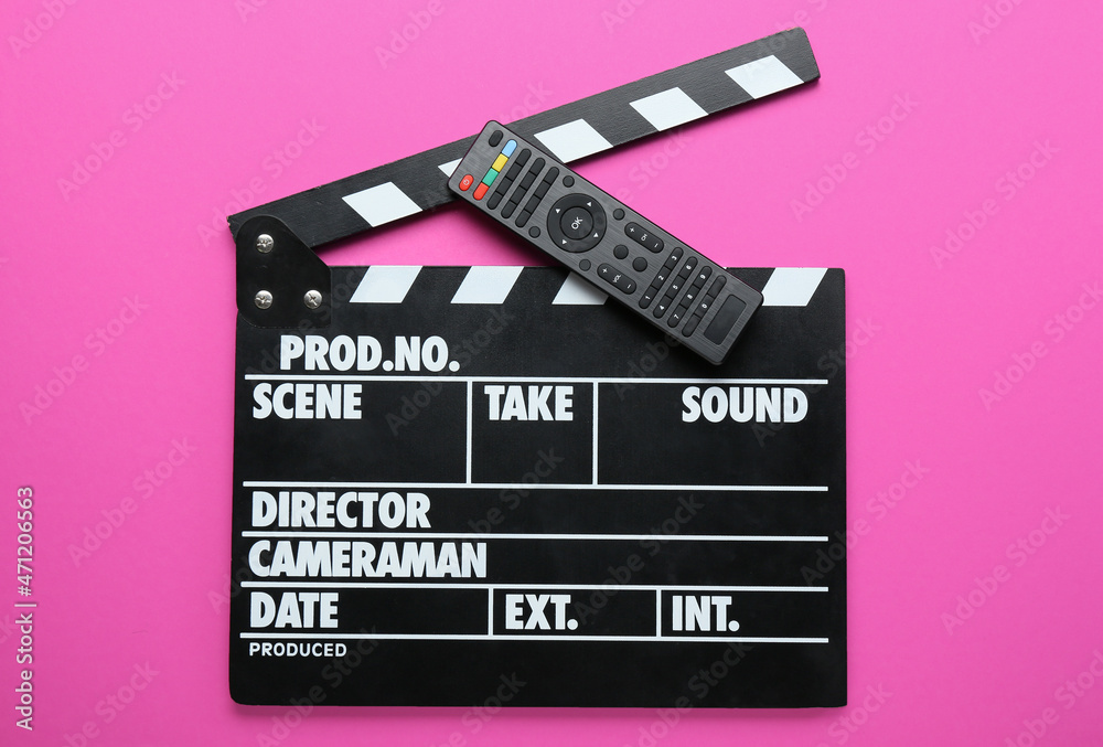 Modern TV remote control and clapperboard on pink background