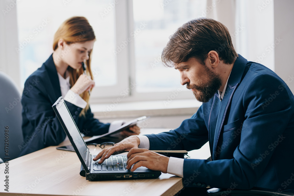 managers in the office in front of a laptop career network professionals