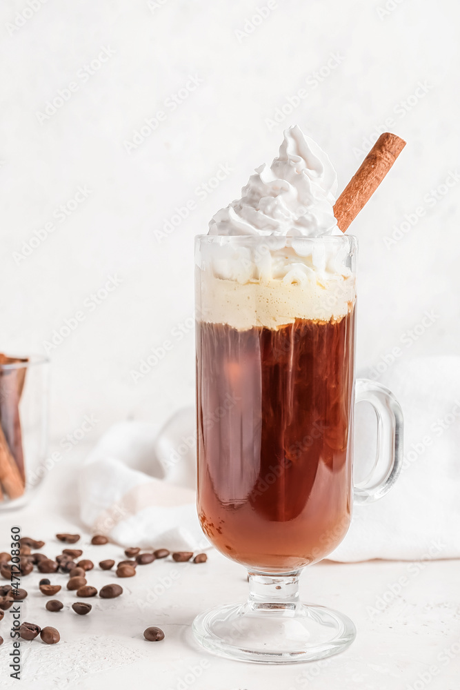 Glass cup of tasty coffee with cinnamon on light background Glass cup of tasty coffee with cinnamon on light background