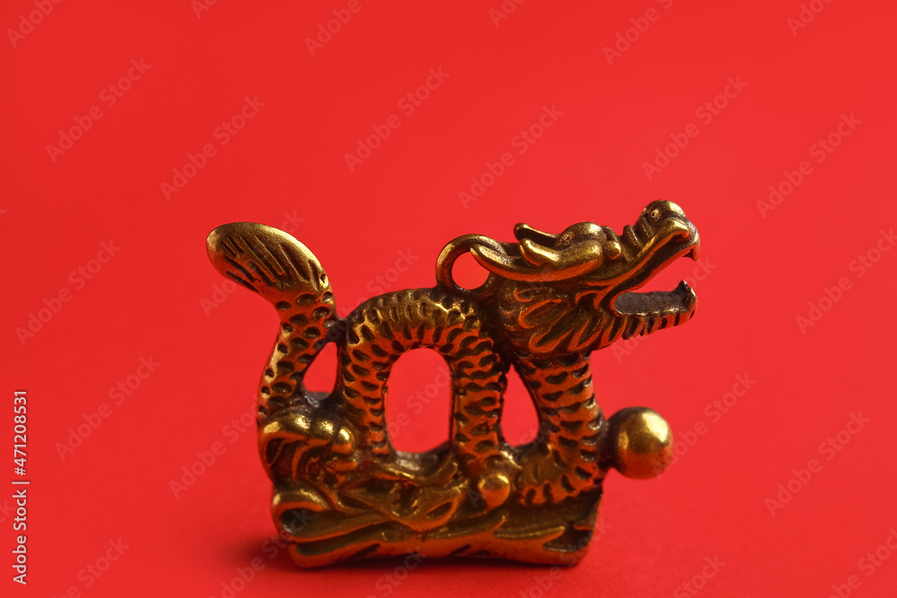 Fototapeta premium Figurine of Chinese dragon on color background