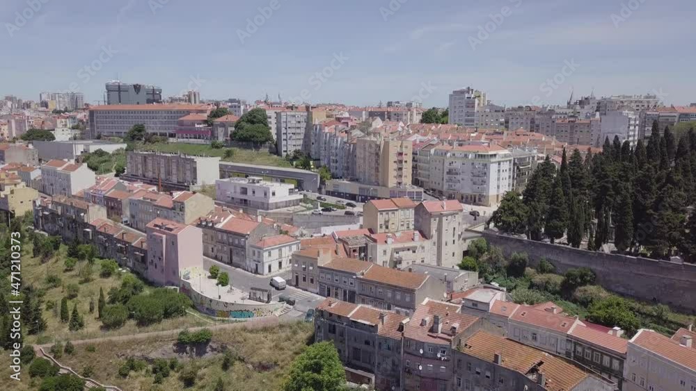 Aerial drone shot in Lisbon neighborhood Casal Ventoso. Slowly dropping down.