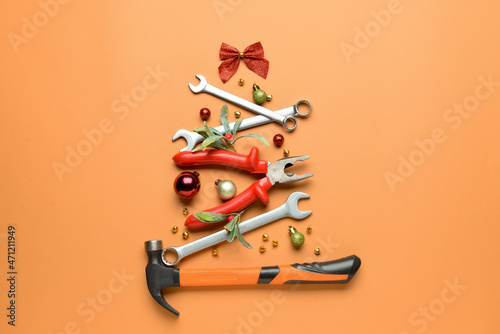 Christmas tree made of construction tools on color background
