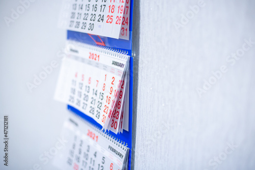 The calendar hangs on the wall.