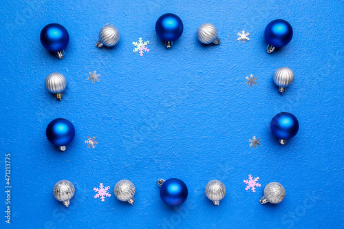 Frame made of stylish Christmas decor on blue background