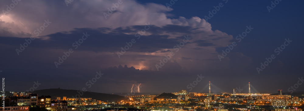 Lightning storm at night over city.