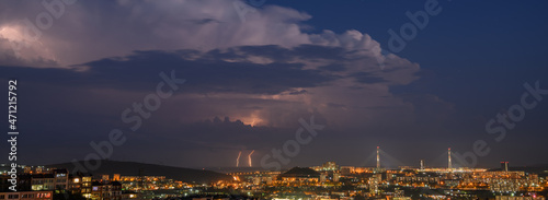 Lightning storm at night over city.