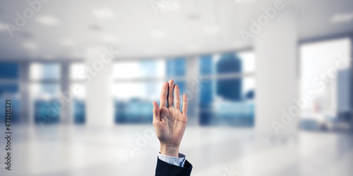 Choosing gesture of businessperson in elegant modern interior in sunshine light