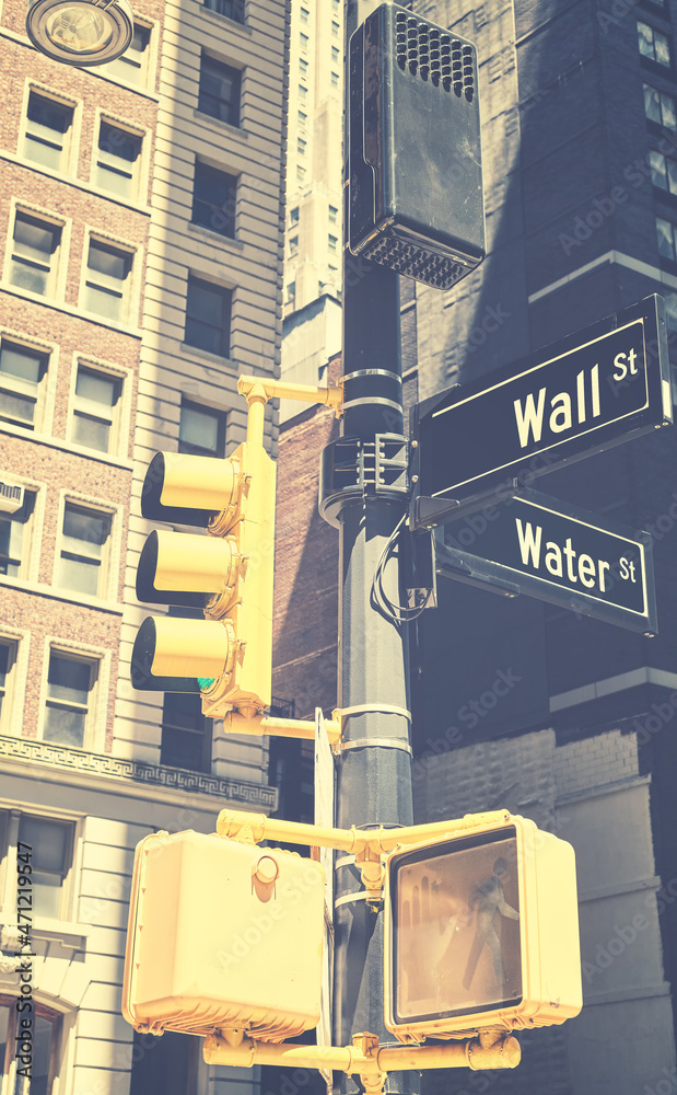 Traffic lights pole with Wall Street and Water Street in downtown New York, retro color toning applied, USA. Traffic lights pole with Wall Street and Water Street in downtown New York, retro color toning applied, USA.