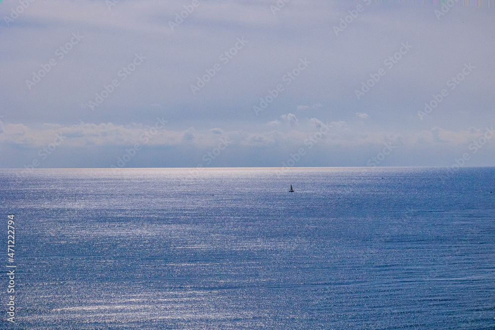 alm blue seaside landscape with water and sky and sailboats