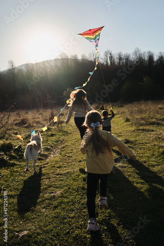 Fotografie Mom with daughter and son and white half-breed dog