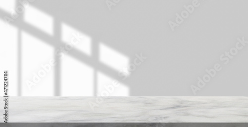 Obraz na plátně Marble table with window shadow drop on white wall background for mockup product