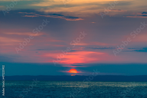 Evening sky with dramatic clouds over the sea. Dramatic sunset over the sea. © kosmos111