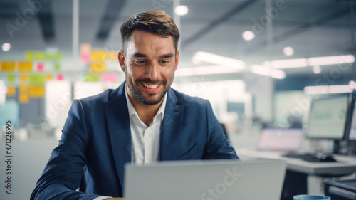 Wallpaper Mural Busy Young Businessman Using Laptop Computer in Modern Office. Manager Thinks About Successful Financial Ideas. Happy Man Smiling About Finding Problem Solving Solutions for Company. Torontodigital.ca