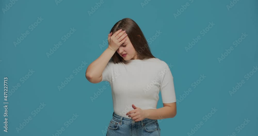 Frustrated sick girl suffering headache, rubbing forehead to relieve migraine pain. Flu symptom, long covid syndrome Frustrated sick girl suffering headache, rubbing forehead to relieve migraine pain. Flu symptom, long covid syndrome