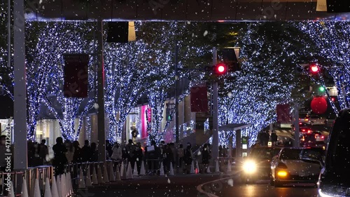 TOKYO, JAPAN - NOV 2021 : Christmas illumination, led light up and snow at Roppongi Keyaki-zaka (Keyaki hill). Scenery of downtown city and street at night. Winter and Christmas season concept. photo