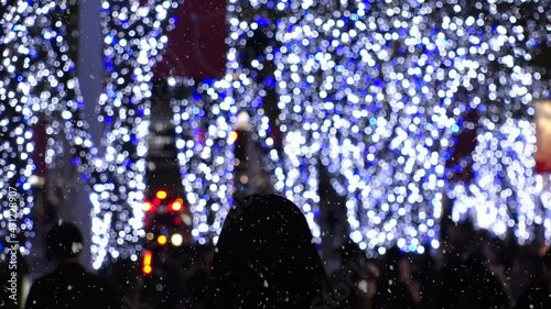 TOKYO, JAPAN - NOV 2021 : Christmas illumination, led light up and snow at Roppongi Keyaki-zaka (Keyaki hill). Scenery of downtown city and street at night. Winter and Christmas season concept. photo