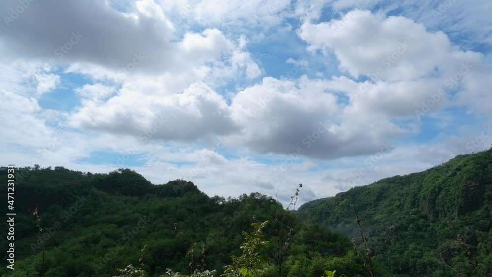 view of the mountains from the top of the hill with blue sky and clouds view of the mountains from the top of the hill with blue sky and clouds
