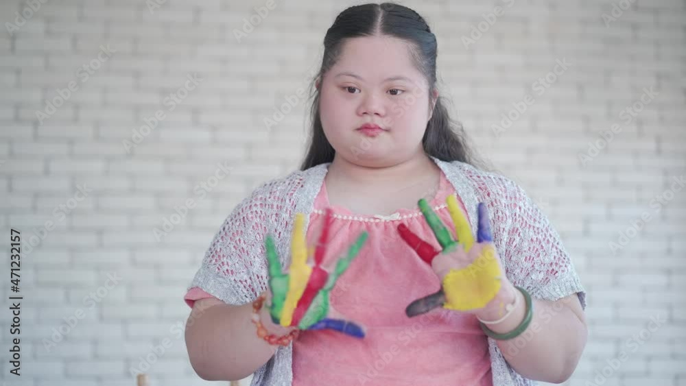 Asian girl with Down syndrome during art painting with mother at home Asian girl with Down syndrome during art painting with mother at home