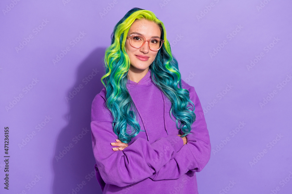 Photo of youth lady with artificial teal blue hairdo cross arms isolated over purple color background Photo of youth lady with artificial teal blue hairdo cross arms isolated over purple color background