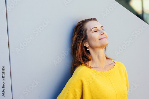 Blissful woman enjoying quality time to relax and de-stress