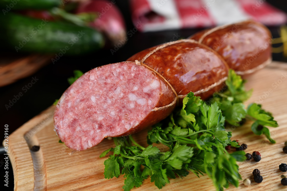 salami and sausage on wooden board