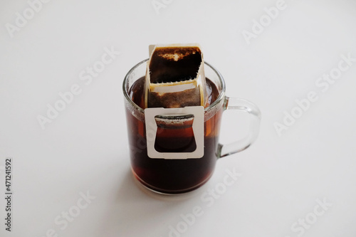 Drip bag coffee on glass cup. Instant freshly brewing method