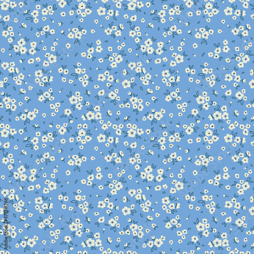 Vector seamless pattern. Pretty pattern in small flowers. Small white flowers. Pale blue background. Ditsy floral background. The elegant the template for fashion prints. Stock vector.