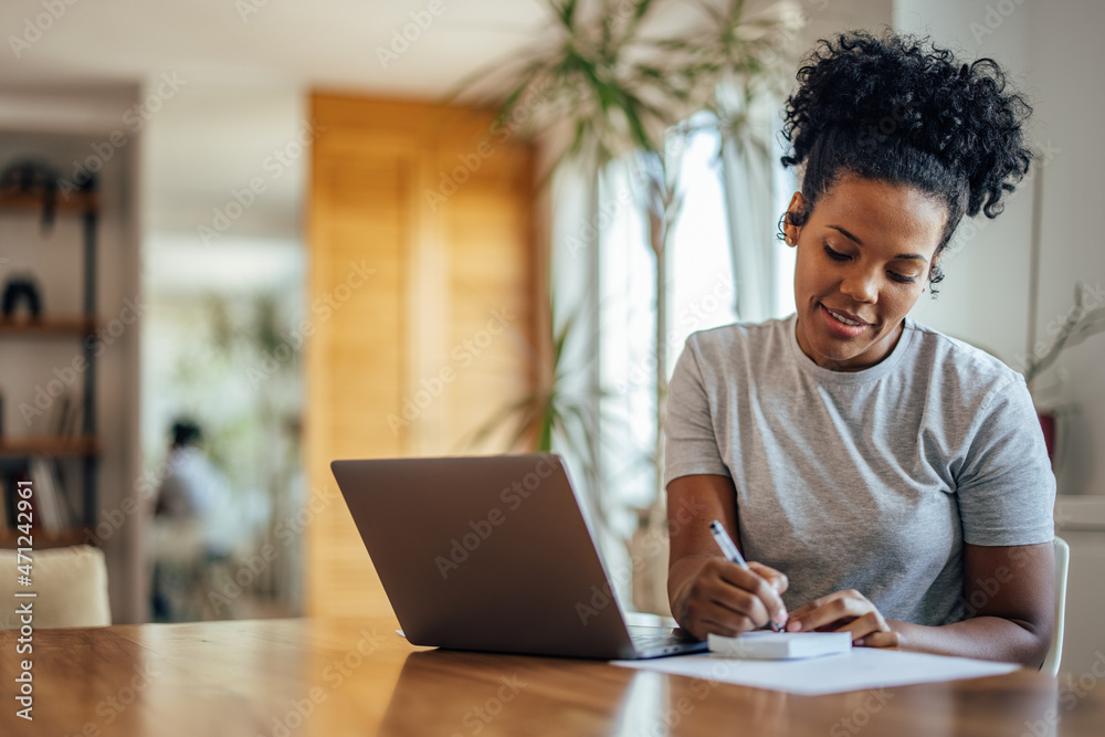 Adult african-american woman, using a notepad. Adult african-american woman, using a notepad.