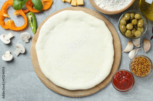 Concept of cooking pizza on gray textured background