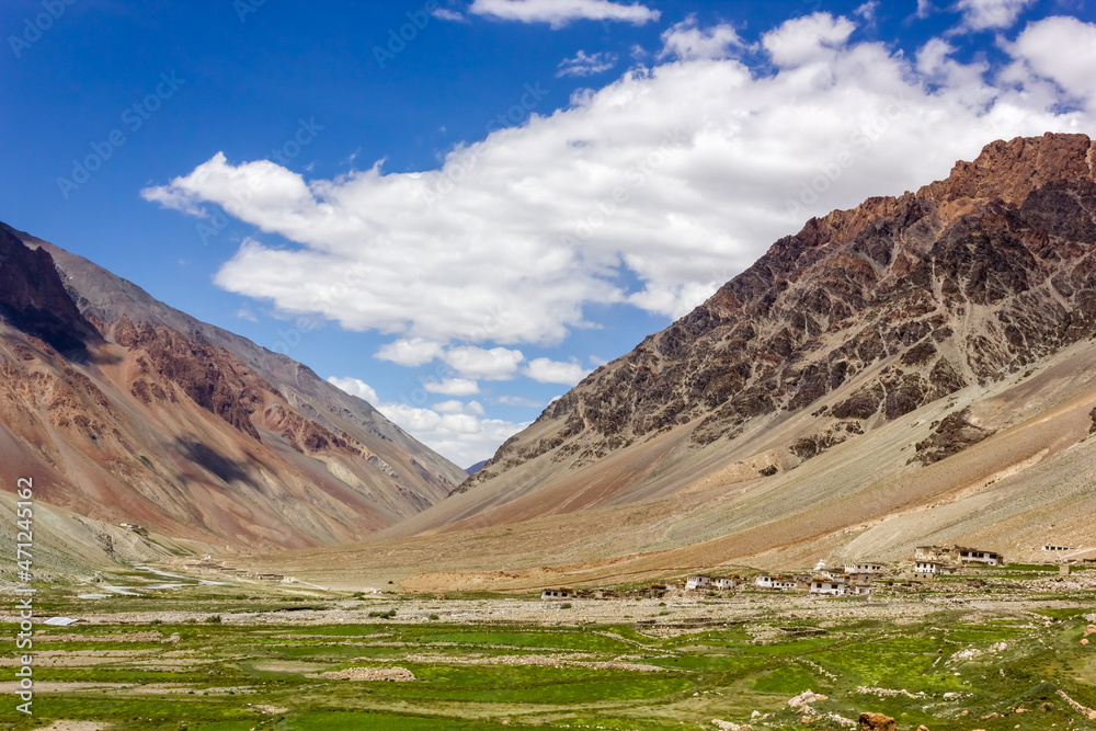 Green fields and high mountains of the village of Kargiak in the Zanskar region of Ladakh in the Indian Himalaya.
