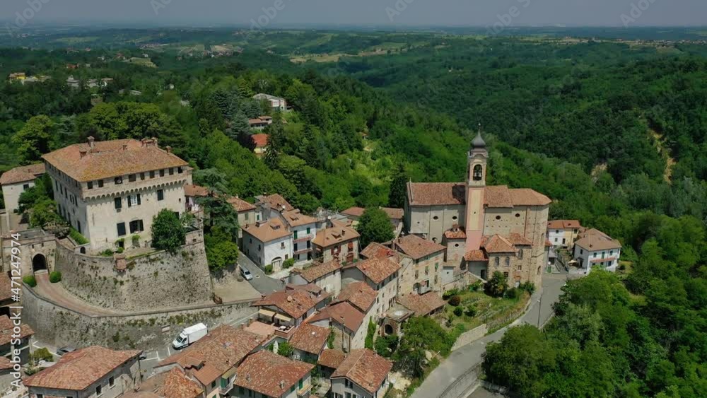 Aerial view towards the Montaldeo Castle and town, in Piedmont, Italy - circling, drone shot Aerial view towards the Montaldeo Castle and town, in Piedmont, Italy - circling, drone shot