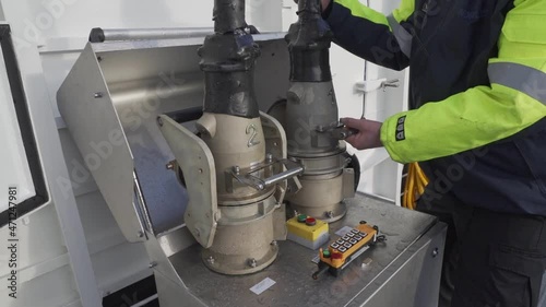 Crew onboard electric ferryboat disconnecting high voltage charging cables - Handheld photo