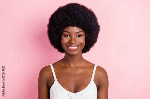 Photo of optimistic millennial brunette hairdo lady wear white top isolated on pastel pink color background