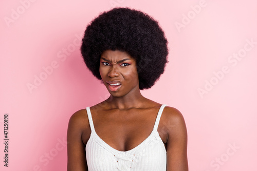 Photo of sad millennial curly hairdo lady dislike wear white top isolated on pastel pink color background