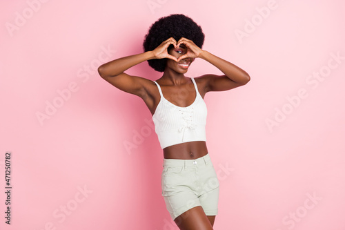 Photo of romantic flirty lady showing heart gesture cover eye wear cropped top isolated pink color background