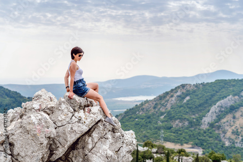 Young woman on a background of mountains