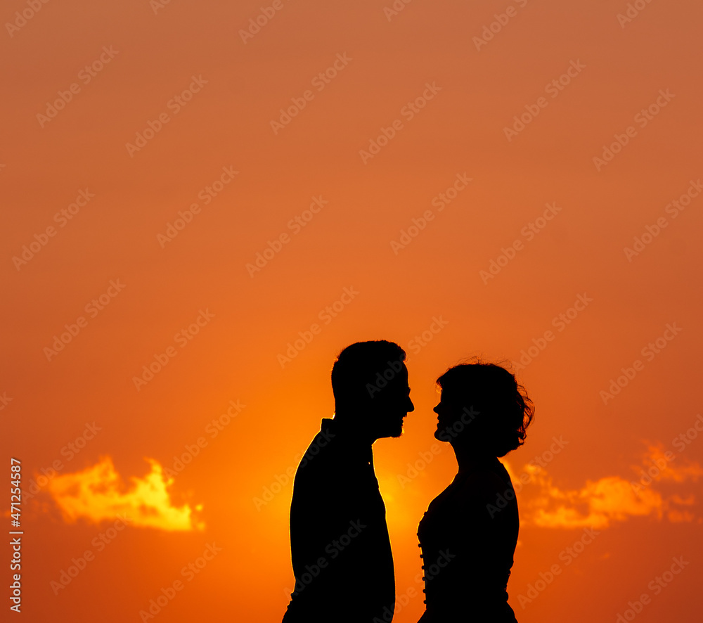 Couple in sunset, silhouette, love and friendship, Azores beach.
