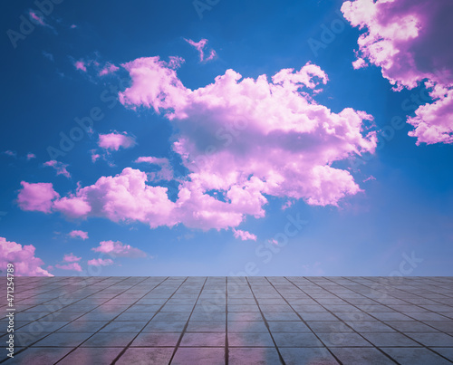 pink clouds, blue sky, gray floor.