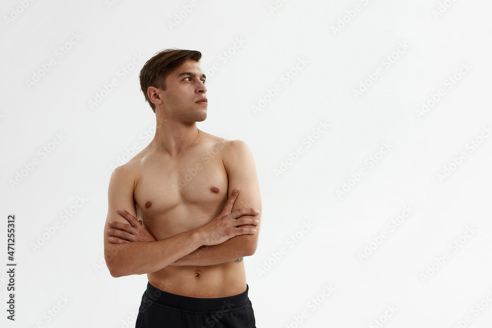Young ballet dancer with crossed arms looking away