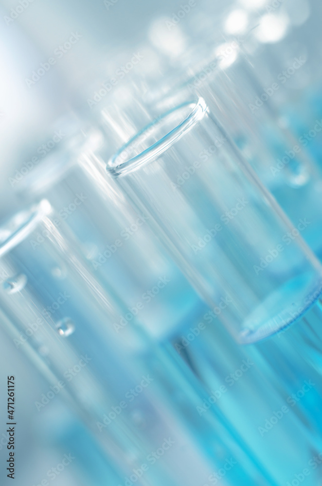Laboratory test tubes with blue liquid close up, selective focus. Scientific laboratory research and experiments Laboratory test tubes with blue liquid close up, selective focus. Scientific laboratory research and experiments