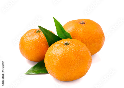 Tangerines or clementines with green leaf on white background.