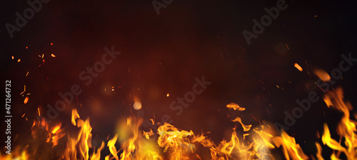  Fire embers particles over black background. Fire sparks background. Abstract dark glitter fire particles lights. photo