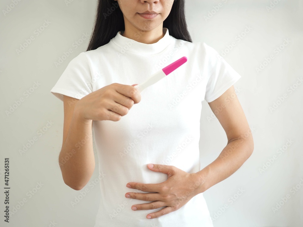 woman holding positive pregnancy test. closeup photo, blurred. woman holding positive pregnancy test. closeup photo, blurred.