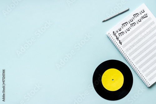 Sheets with music notes and vinyl record. Compose music concept