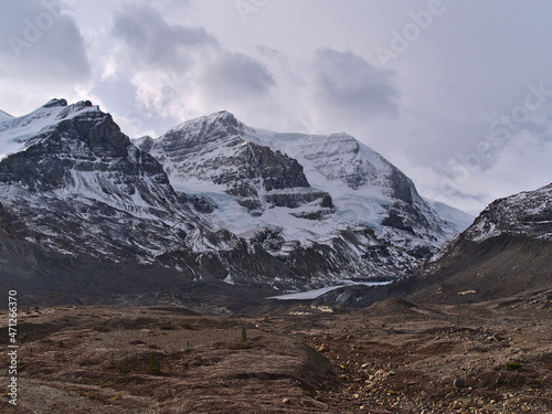 Rugged landscape with majestic snow-capped Mount Athabasca in Jasper National Park, Alberta, Canada with rocky glacial moraine in front on cloudy day.