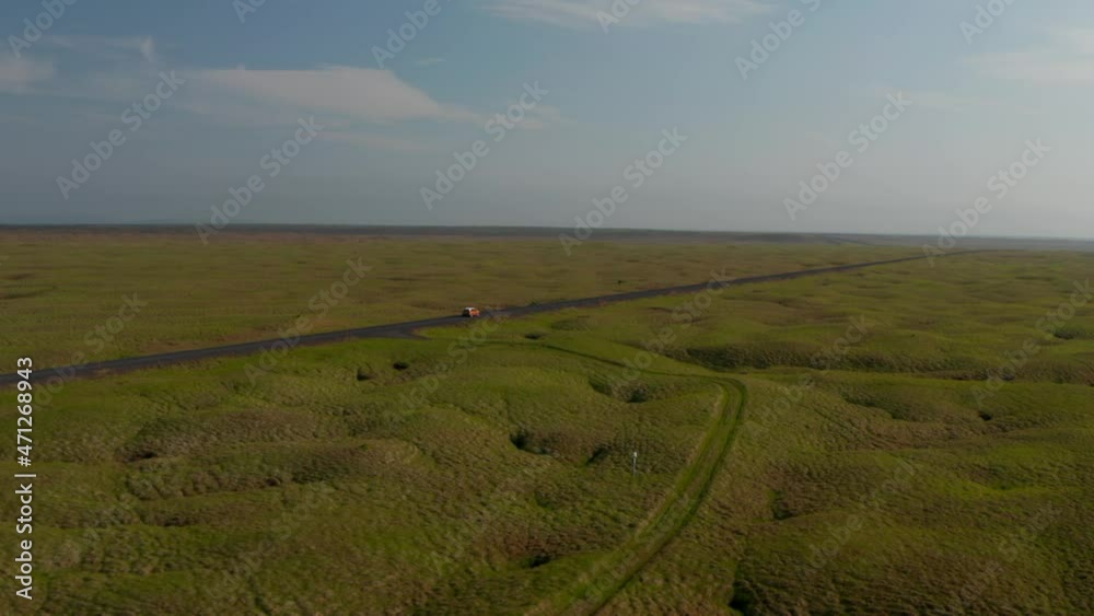 aerial view car driving on Ring Road, the most important highway in Iceland. Drone view car travelling on Ring Road discovering uninhabited parts of Iceland aerial view car driving on Ring Road, the most important highway in Iceland. Drone view car travelling on Ring Road discovering uninhabited parts of Iceland