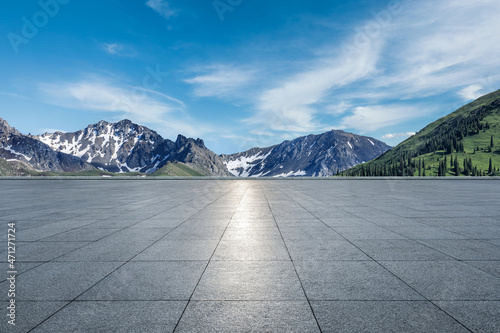 Empty square floor and mountains under blue sky. Road and mountain background. © ABCDstock