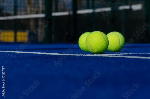 three balls on a paddle tennis court, selective focus © Vic